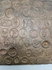 Bronze relief med romerske bordel mønter