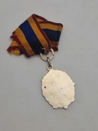 Orignal bl.a. medalje fra føringsstøtteelementet