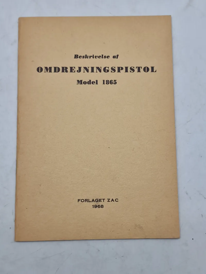 Beskrivelse af
OMDREJNINGSPISTOL
Model 1865