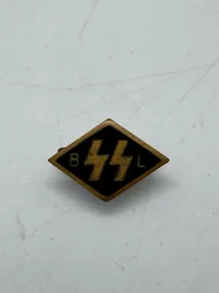 Original SS. A Flemish SS Supporting Member’s Pin,double Sig runes flanked by initials “BL” for Begunstigende Ledenspeld