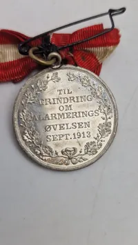 Original mindemedalje, der blev udstedt "TIL ERINDRING OM ALARMERINGS ØVELSEN SEPT. 1913"