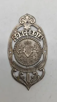 Originalt gammelt cykelhovedskilt ("Steuerkopfschild") med teksten "CONCORDIA Schutz Marke".
