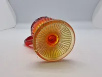 Glas opsats og kande fra Fyens Glasværk, opsatsen og kanden er i presset glas. Skålen, på opsatsen, er rød og stilken er gul, farverne fader ud fra rød til gul