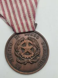 Original "Medaglia al Merito di Servizio" (Tjenestefortjenstmedalje) eller "Croce per Anzianità di Servizio" (Kors for Anciennitet i Tjeneste)
