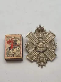 regimentsmærkeWW1/WW2  for The Gordon Highlanders, et tidligere infanteriregiment i den britiske hær.