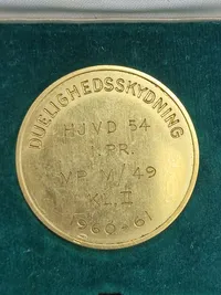 Original mønt for duelighedsskydning i HJV med æske