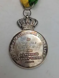 Original medalje fra Det Kongelige Patriotiska Sällskapet, tildelt Rudolf Ekberg for "Långvarig trogen tjenst" (langvarig trofast tjeneste).