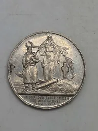 medalje med inskriptionen "FOR DEM DER FALDT OG DEN DER BLEV TILBAGE 1864-1914". medaljen er et mindesmærke for begivenhederne i perioden 1864-1914