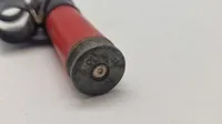 Løs 12,7 mm patron i plast med led. Afskudt