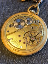 Tissot lommeur med bagkasse af 18 karat guld (bagkasse vejer ca 3 gram)