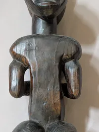 African Carved Dark Wood Fertility Figure with Brass Eye Inlays