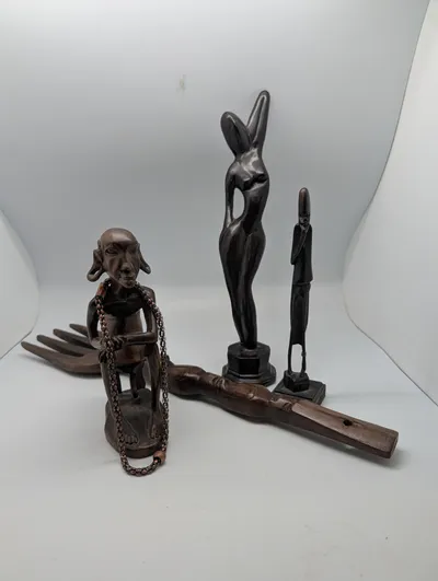Collection of Four Hand-Carved African Ebony Wood Sculptures and Utensil