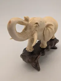 Vintage Carved Faux-Ivory Elephant Figurine on Wooden Stand