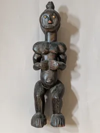 African Carved Dark Wood Fertility Figure with Brass Eye Inlays