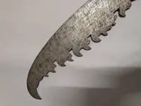 Antique Southeast Asian Dha Sword with Ornate Brass Hilt and Serrated Blade