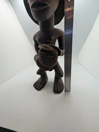 Hand-Carved African Wood Sculpture of a Drummer with Traditional Headdress