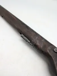 Dekorativ flintlåspistol i træ og metal med ornamenterede detaljer