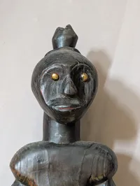 African Carved Dark Wood Fertility Figure with Brass Eye Inlays
