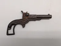 Antik støbejerns legetøjspistol med patentdatoer fra 1887