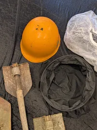 Militært udstyr med feltspader, gasmasker og hjelm