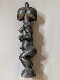 African Carved Dark Wood Fertility Figure with Brass Eye Inlays