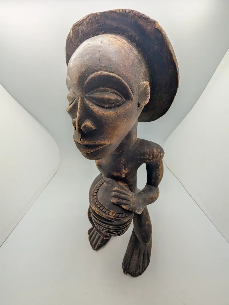 Hand-Carved African Wood Sculpture of a Drummer with Traditional Headdress