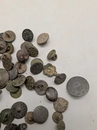 Samling af antikke og historiske metalknapper med dekorative motiver