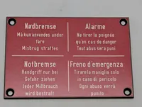 Vintage skilt med Nødbremse-instruktioner på fire sprog DSB