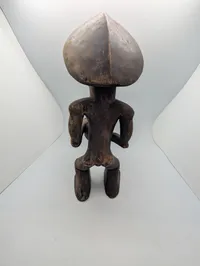 Hand-Carved African Wood Sculpture of a Drummer with Traditional Headdress