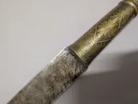 Antique Southeast Asian Dha Sword with Ornate Brass Hilt and Serrated Blade