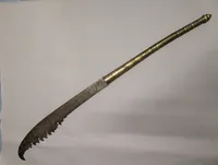 Antique Southeast Asian Dha Sword with Ornate Brass Hilt and Serrated Blade