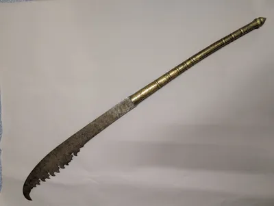 Antique Southeast Asian Dha Sword with Ornate Brass Hilt and Serrated Blade