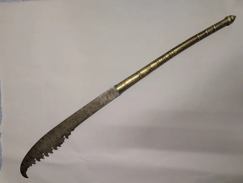 Antique Southeast Asian Dha Sword with Ornate Brass Hilt and Serrated Blade