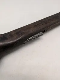 Dekorativ flintlåspistol i træ og metal med ornamenterede detaljer