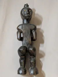 African Carved Dark Wood Fertility Figure with Brass Eye Inlays