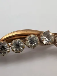 Vintage broche i guldtonet metal med seks facetslebne krystaller