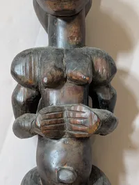 African Carved Dark Wood Fertility Figure with Brass Eye Inlays