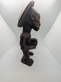 Hand-Carved African Wood Sculpture of a Drummer with Traditional Headdress
