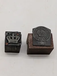 To antikke bogtrykkerstempler med den danske kongekrone og elefantordenen