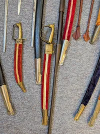Collection of Antique and Decorative Swords, Sabers, and Daggers