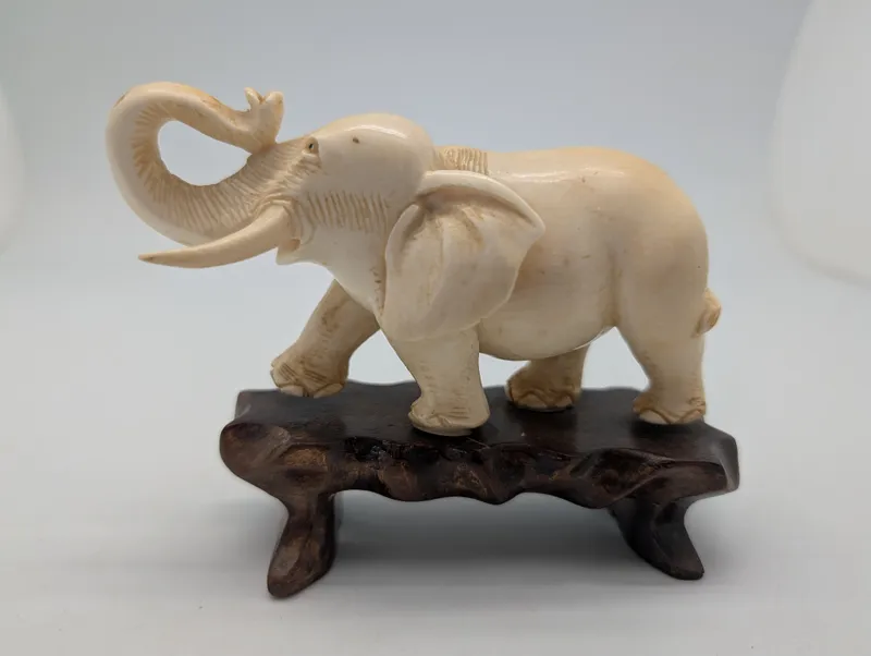 Vintage Carved Faux-Ivory Elephant Figurine on Wooden Stand